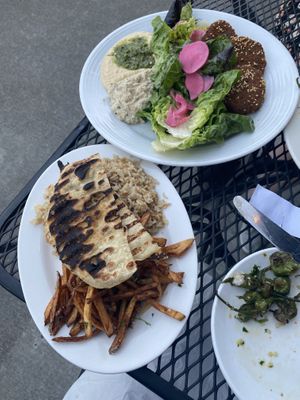 Fava bean falafel, with hummus and baba ghanoush, a farmers green salad; shoestring potatoes; rice and orzo; and flatbread at Allyum in Seattle