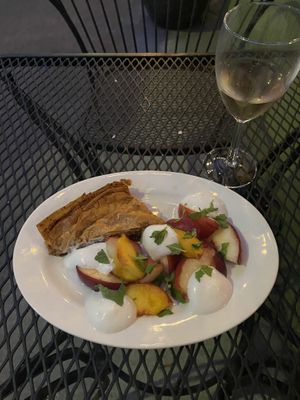 Baklava, with fresh peaches, mint, and coconut whipped cream at Allyum in Seattle