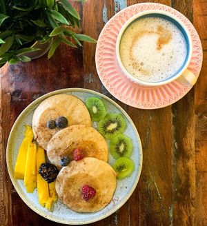 Pancakes with season fruits and coffee with organic soya milk at Vizzio Cafe in Lisbon