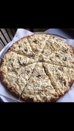 Create your own pizza with Alfredo sauce and mushrooms 🤤 at Vegan Korner in Grand Terrace