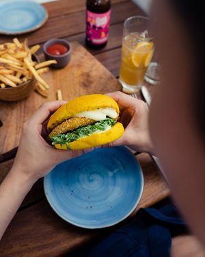 The chick-un burger in turmeric bun with vegan mayo  at The Stables Whitford in Auckland