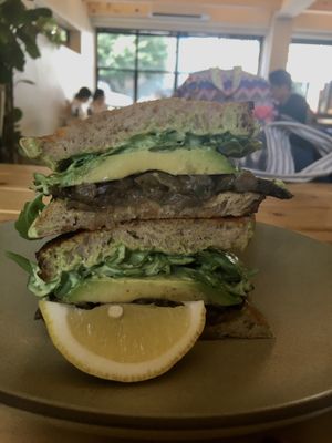 Vegan forest mushroom sandwich with avocado, rocket, hummus, caramelized onions, and sautéed mushrooms on sourdough  at Little Aus - 리틀오스 in Busan