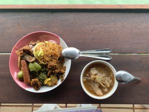 A mix of spicy and non-spicy dishes on mixed rice with a basic vegetable soup. The food wasn’t hot, but it was flavourful. at Tamachat Vegan Food - ธรรมชาติ in Koh Samui