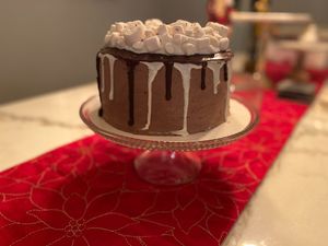 Hot cocoa cake. Chocolate cake, chocolate & vanilla marshmallow frosting, semi sweet & white chocolate drip, & marshmallows at GG's Vegan Bakery in Bozrah
