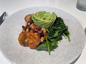 Picnic Cafe’s House Baked Beans, with roasted tomato instead of mushrooms. The baked beans mix has onion  in it. at Picnic Cafe in Hobart