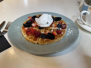 Picnic Cafe’s Mixed Berries waffle, with maple syrup and vegan vanilla ice cream. at Picnic Cafe in Hobart