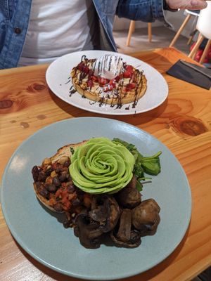 Belgium waffle in the background, main focus is beans on sourdough. at Picnic Cafe in Hobart