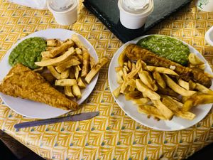 Tofu fish and chips with gravy and mushy peas, battered bratwurst with curry sauce and mushy peas. at JJ's Vish & Chips in Manchester
