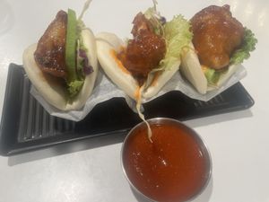 Herbivore bao with side of siracha. The Korean fried cauliflower is outstanding!   at Po-Ké Ono in Oranjestad