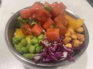 Watermelon Poke bowl with mango, avocado, edamame, crispy corn, wakame, sweet potato, pickled cucumber, red cabbage, sweet chili dressing tossed in tamari poke dressing.  at Po-Ké Ono in Oranjestad