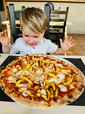 Pizza with vegan cheese, vegan bacon, chips and peppers  at Chris Kitchen in Fuerteventura