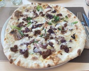 Vegan pizza with vegan mozzarella, chicory and vegan bacon   at Chris Kitchen in Fuerteventura