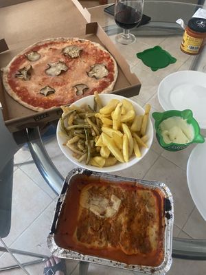 Takeaway - Pizza, chips and lasagna from Chris Kitchen. Zucchini fries and vegan allioli from supermarket   at Chris Kitchen in Fuerteventura
