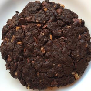 Warm thick and chewy double chocolate chip cookie with walnuts at Angelica Kitchen in New York City