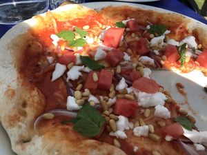 Once in a melon pizza with vegan feta cheese, fresh mint, pine nuts, red onion at Sundlingska Gården in Tavelsjo