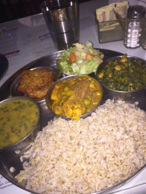 Entrees of lentils, curried tofu and veggies, and spinach with chickpeas  at Ayurveda Cafe in New York City