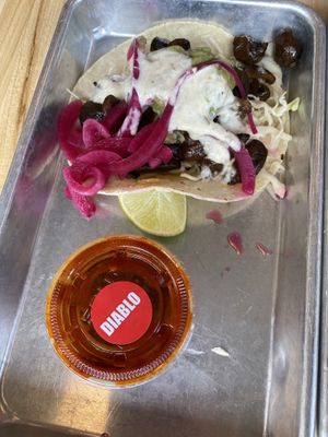 Taco and hot sauce   at Más Veggies Taqueria in Cambridge