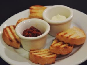 Bread plate with sundried tomato, the other isn't vegan at Eatcetera in Galveston