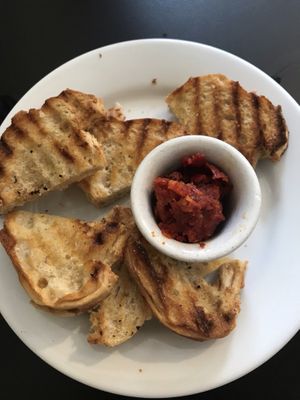 Complimentary appetizer of toasted bread (vegan) along with a spread (vegan) at Eatcetera in Galveston