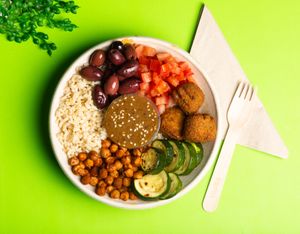 Fibrous Falafel - Vegan Nourished Lunch Bowl

Served with kalamata olives, tomato, brown rice, spiced chickpeas, and zucchini, on a bed of mesclun with Moroccan-inspired Dressing. at Nomads Eatery in Brisbane