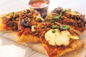 Flatbread Pizza: roasted tomato, asparagus,
kalamata olives, basil pesto, tempeh chorizo, almond
ricotta cheese, cashew parmesan at Candle Cafe in New York City