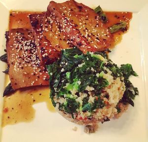 Orange sesame seitan- grilled asparagus, coconut-vegetable quinoa pilaf, orange sauce and sesame seeds. at Candle Cafe in New York City