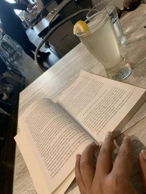 Coconut water and a book. Perfect combo for the summer  at Candle Cafe in New York City