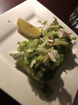 Raw avo-wild Greens sandwich - homemade raw coconut bread, avocado , raw almond hummus and raw pesto fresh tomato and raw Ali-oli with mixed greens, onions, radish and sprouts   at Caravan of Dreams in New York City