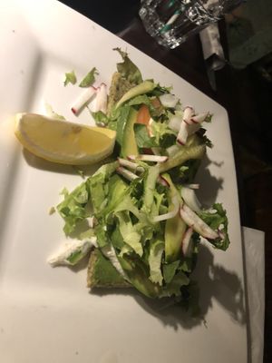 Raw avo-wild Greens sandwich - homemade raw coconut bread, avocado , raw almond hummus and raw pesto fresh tomato and raw Ali-oli with mixed greens, onions, radish and sprouts   at Caravan of Dreams in New York City