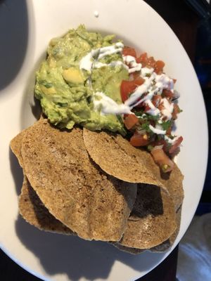 Raw nachos : flax mango chips, guacamole, salsa, olives, almond cream   at Caravan of Dreams in New York City
