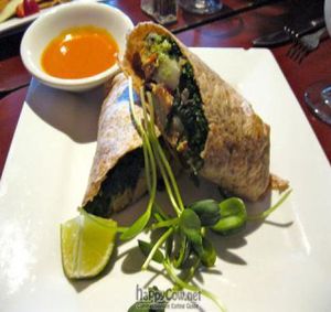 Breakfast Burrito with potatoes, sautéed kale, guacamole, smoked tofu, chile de árbol. at Caravan of Dreams in New York City
