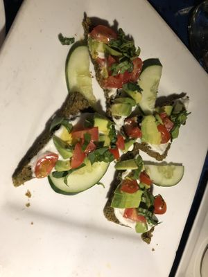 Raw avocado Bruschetta - home made raw coconut bread, house made raw Ali oil, tomato, basil, olives 
(Olives)  at Caravan of Dreams in New York City