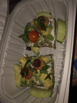  Raw avocado bruschetta- home made raw coconut bread, house made raw Ali oil, tomato, basil,olives( no olives)   at Caravan of Dreams in New York City