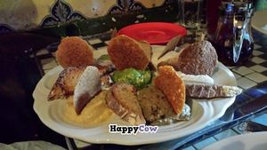 Caravan Sampler Tapas: Raw hummus, Arabian hummus, pesto, guacamole, smoked eggplant spread, House made herbed Cashew keﬁr and Ali-oli  at Caravan of Dreams in New York City