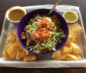 Vegetarian Crumble Bowl (vegan as is) with Tomatillo salsa (right). Side of chips and Rajas salsa (left). The plant-based crumble is wonderfully seasoned. Great home-made salsas. at El Camino Gourmet Tacos in Edina