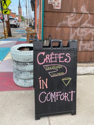 Outside sign on sidewalk at Give a Crepe in Erie