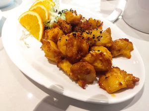 Fried monkey head mushrooms with orange sauce and black sesame seeds at Heartful Veggie 從心素食 in New Territories