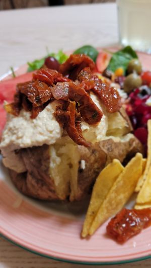 Baked potato with hummus & sun dried tomatoes at Cafe U in Kelso