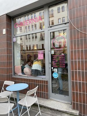 One table outside and Happy Cow decal on window!  at Baja Wegańska Cukiernia in Warsaw