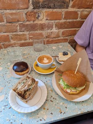 Chickpea patty and tartare sauce sandwich with soda bread, vegan egg mayo brioche, Boston cream doughnut and lemon cheesecake at Baja Wegańska Cukiernia in Warsaw