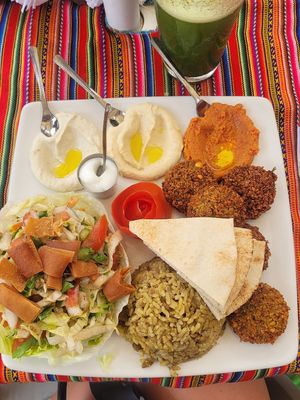 Vegan platter with Fatush salad, hummus, paprika paste, aubergine paste, falafel and lentil rice ☺️ at Barba Beach Arabic Food  in Palomino