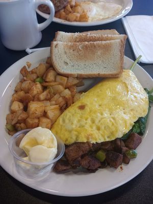 Vegan omelette with steak, mozzarella, mushrooms, and spinach. White toast with vegan butter and diner potatos. at Black & Blue Diner in Las Vegas