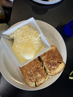 “Chicken” breakfast sandwich.. and those amazingly unhealthy, loaded grits!   at Black & Blue Diner in Las Vegas