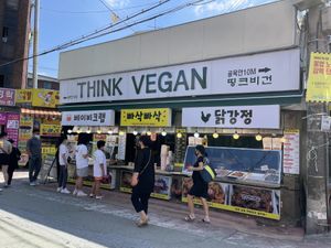 Signage on the main street side. It is hanging at the fried chicken store. What an amazing way to do billboard!  at Think Vegan in Seoul