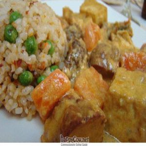 Curried seitan and fried tofu with veggies and fried rice at Loving Hut in Madrid