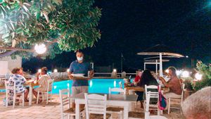 Enjoy a vegan poolside dinning under our amazing ficus tree. at Margarita in Paros