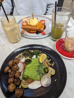 Avocado on toast with mushrooms on the side. Waffles in the back. at Hydrant Food Hall in Ballarat