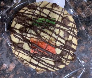 Chocolate chip cookie stuffed and topped with a rainbow cookie  at Bliss Bites Cookies - Maybe closed in Beaufort