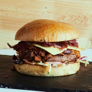Moving Mountains patty on vegan brioche bun, loaded with our ‘chilli non carne’, cheese, red onion jam and our house pomegranate molasses slaw. at Leaf Lovers in Birmingham