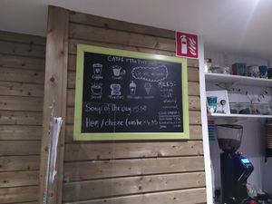 A chalkboard menu with the prices for a toastie and soup of the day. at The Purr in Dublin